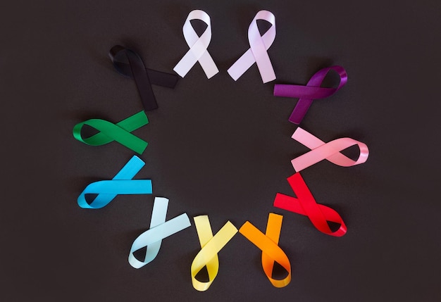 Colored ribbons black background representing the prevention campaigns of the months of the year