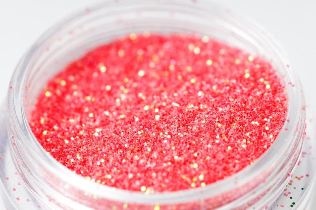 Colored sequins in a plastic jar closeup High quality photo