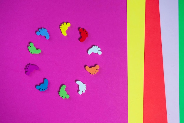 Colored sheets of paper handmade footprints in a circle