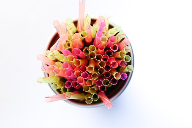 Colored striped bright plastic straws in a jar