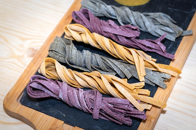 Colored tagliatelle pastas ready for be cooked