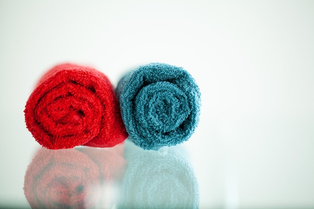 Colored towels on white table with copy space on bath room background