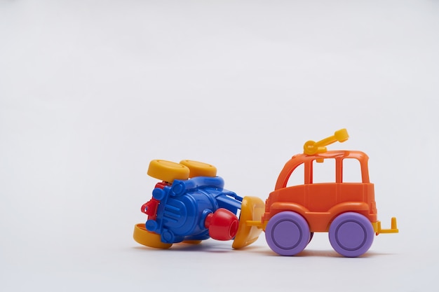 Colored toy cars collided in an accident. Crash on a toy road