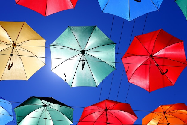 Colored umbrellas on the background of blue sky. High quality photo