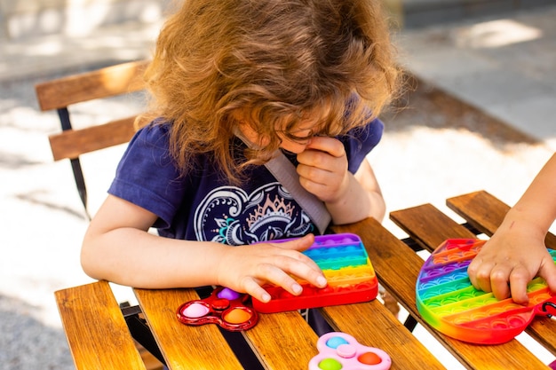 Colorful antistress toy fidget push pop it in kid's hands