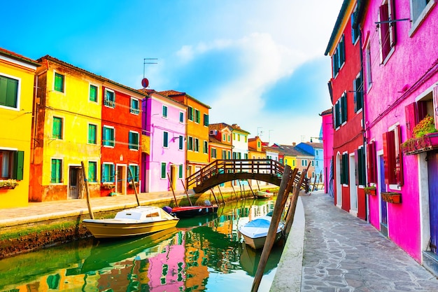 Colorful architecture and canal with boats in Burano island, Venice, Italy. Travel and vacation