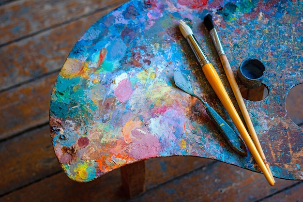 Colorful artist's palette with brushes and oil paints