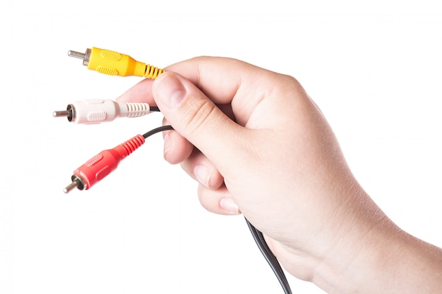 Colorful audio video cable connectors in hand isolated on white .