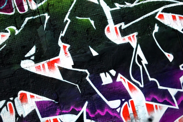 Colorful background of graffiti painting artwork with bright aerosol strips on metal wall