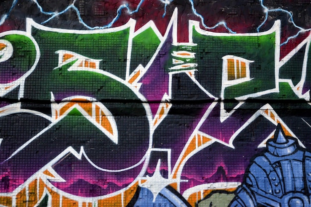 Colorful background of graffiti painting artwork with bright aerosol strips on metal wall