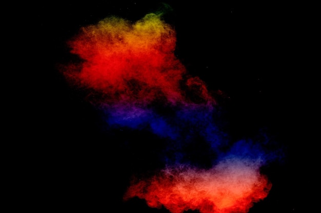 Colorful background of pastel powder explosionMulti colored dust splash on black background