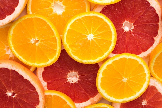 Colorful background with sliced juicy orange and grapefruit