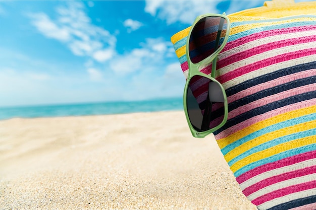 Colorful Bag and Sunglasses  on Summer Beach