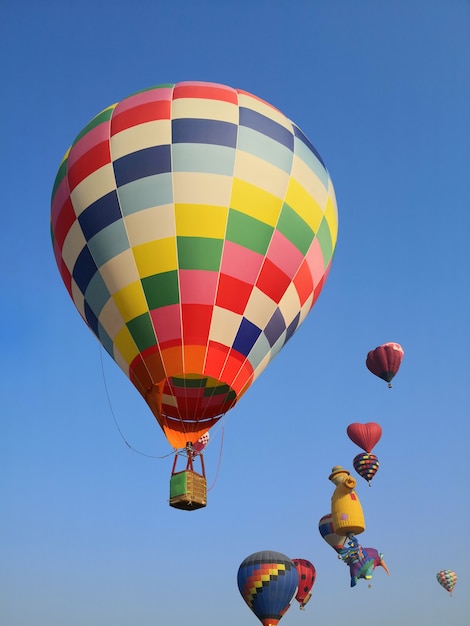 Colorful balloons flying in blue sky