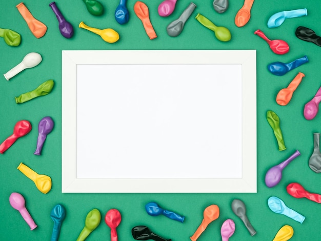 Colorful balloons and frame on colorful background top view Birthday or party mockup