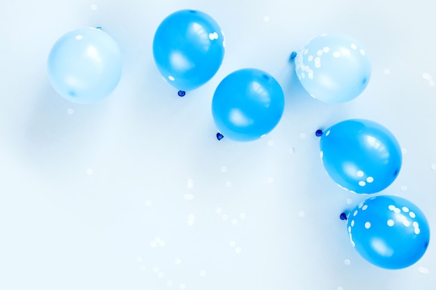 Colorful balloons on pastel blue  background. Festive or birthday party concept. Flat lay, top view.