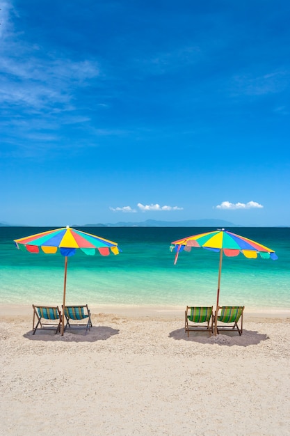 Colorful beach chairs with umbrellas on a sunny day