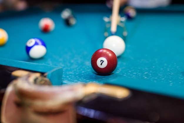 Colorful billiard balls on table in pub macro photo. Gambling concept