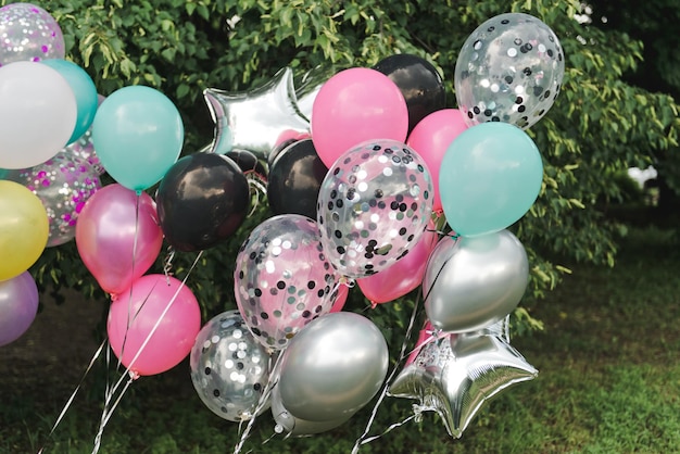 Colorful birthday balloons. Pink, deep, black, silver.