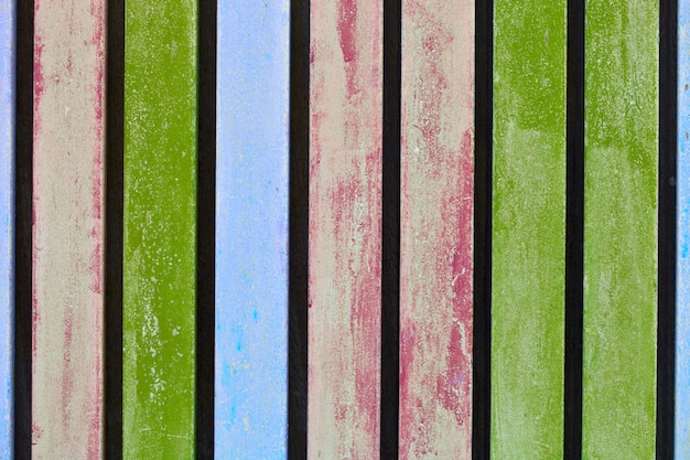 Colorful blue, pink and green wooden aged plank wall.