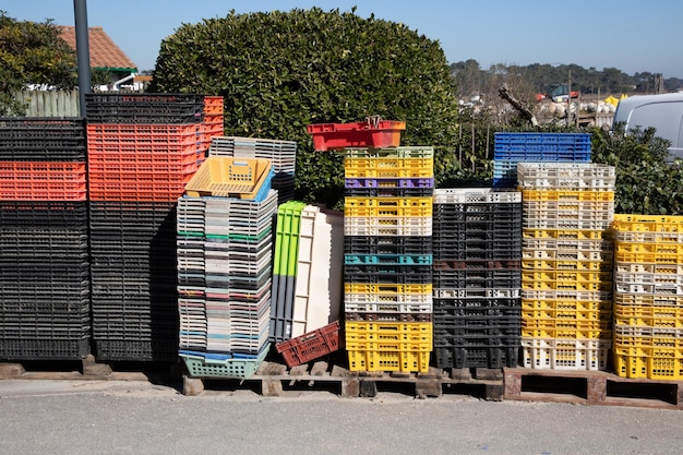 Colorful boxes plastic crates containers for fish oyster mollusk box at the harbour