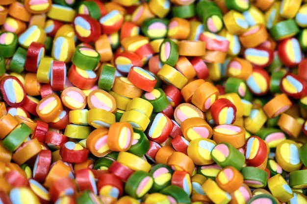 Colorful bright candy, children's joy. The composition of a variety of chocolates by weight in trays.