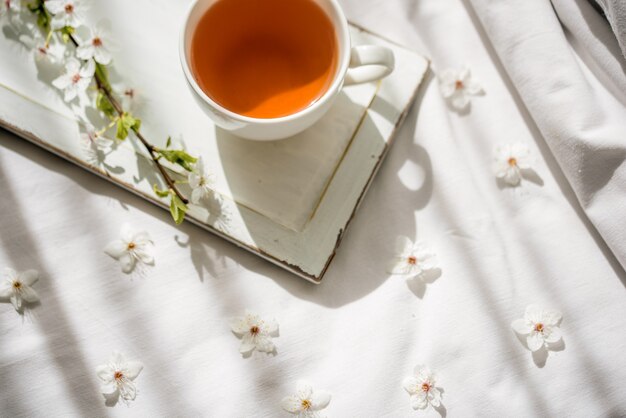 Photo colorful bright floral pattern with tea cup. flat lay.