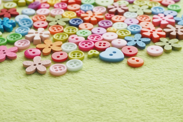 colorful buttons on green plush fabric