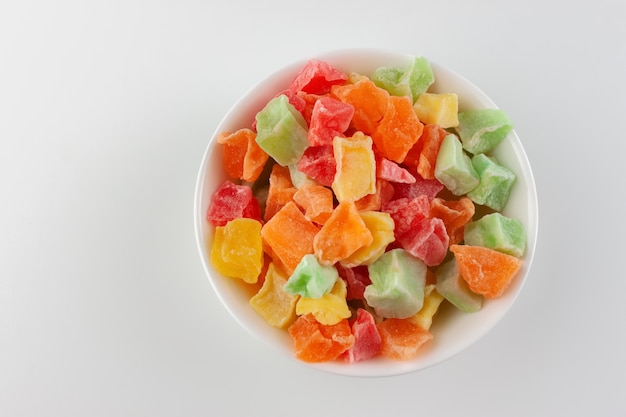 Colorful candied fruits in a white bowl