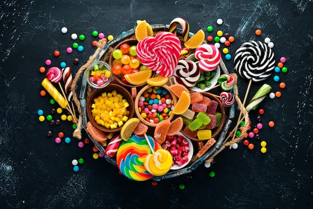 Colorful candies jelly and marmalade in a wooden box Sweets On the old background Top view free copy space