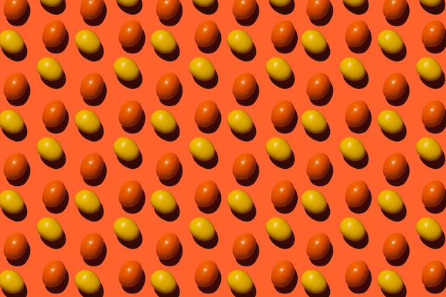 Colorful candies on orange background