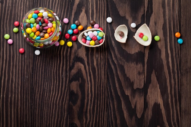 Colorful candies on wooden table