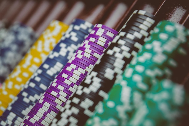 Colorful Casino chips lie on the gaming table in the stack. Background for casino, business, poker