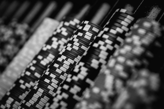 Colorful Casino chips lie on the gaming table in the stack.  casino, poker. black and white photo