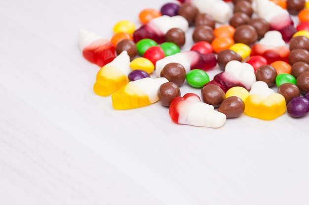 Colorful chocolate, jelly, sugar candies. Top view, copy space.