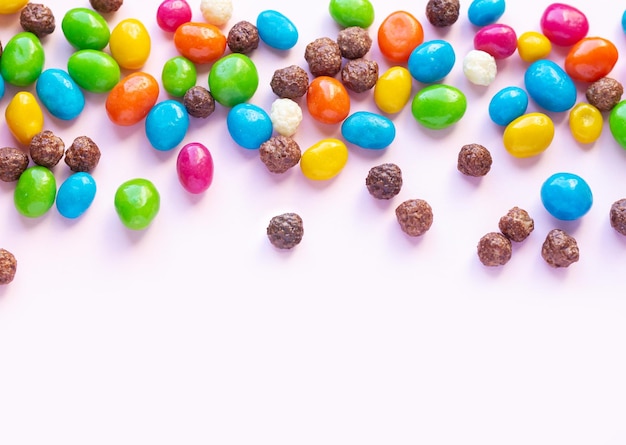 Colorful chocolate and jellybeans candy background top view