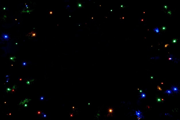 Colorful christmas lights background with copy space in the center.