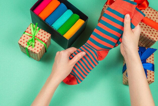 Colorful collection of cotton socks as a gift in woman hands. Gift.