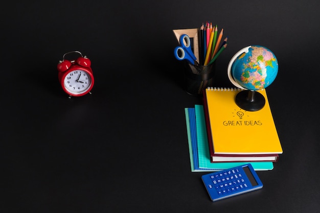 Colorful collection of school supplies set on black background. back to school. top view