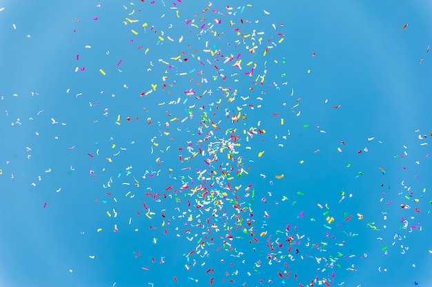 Colorful confetti in the blue sky