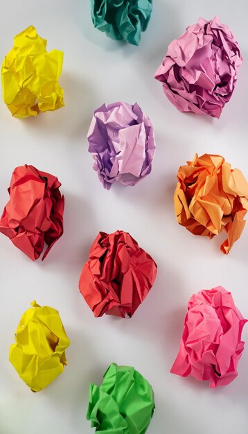 Colorful crumpled paper ball on white background generative ai