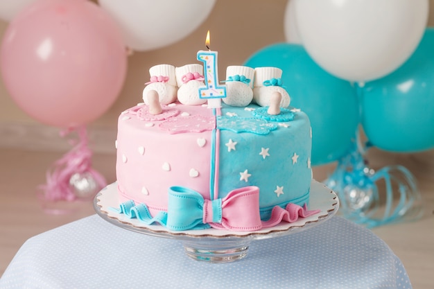 Colorful decoration of a first year birthday cake for twins