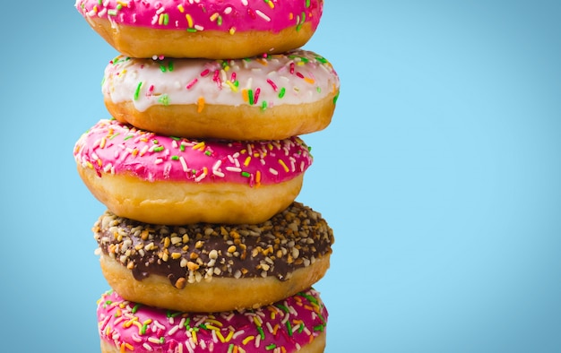 Colorful donuts on blue background