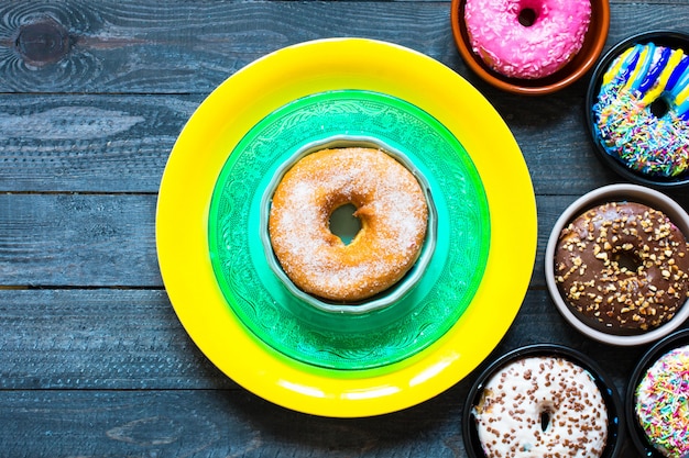 Colorful Donuts breakfast composition with different color styles