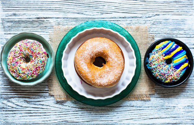 Colorful Donuts breakfast composition with different color styles