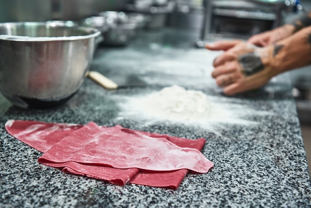 colorful dough for homemade pasta lying on the kitchen table