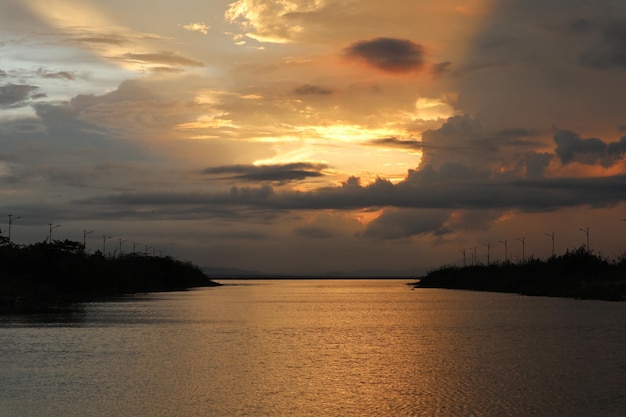 colorful dramatic sky with clouds at sunset. Sunset in  the lake