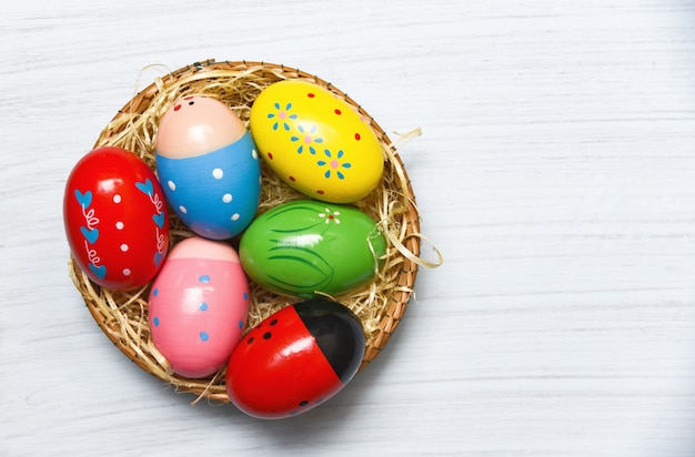 Colorful easter eggs in basket nest decoration 