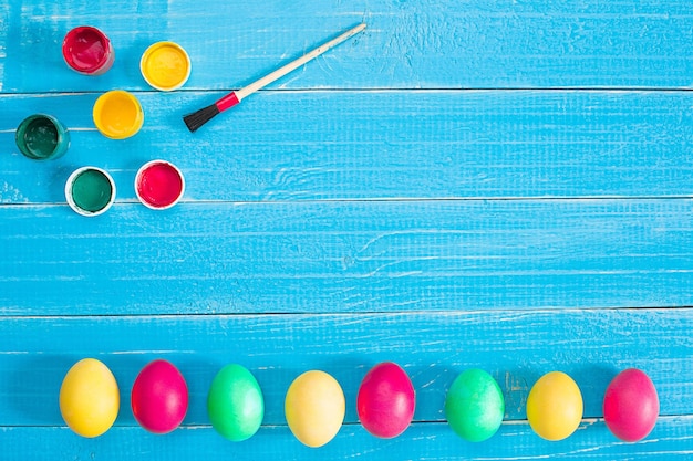 Colorful easter eggs on blue rustic wooden background