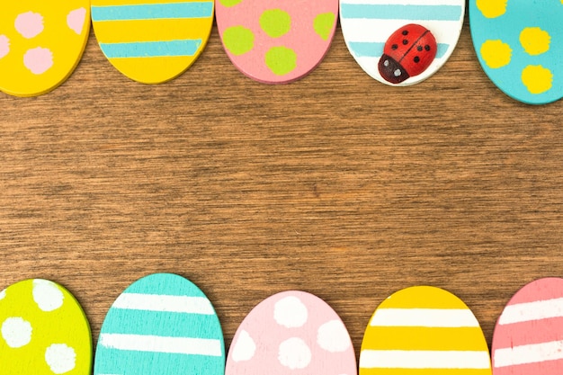 Colorful Easter eggs double side border, old rustic wood background, flat lay design, top view with copy space photo